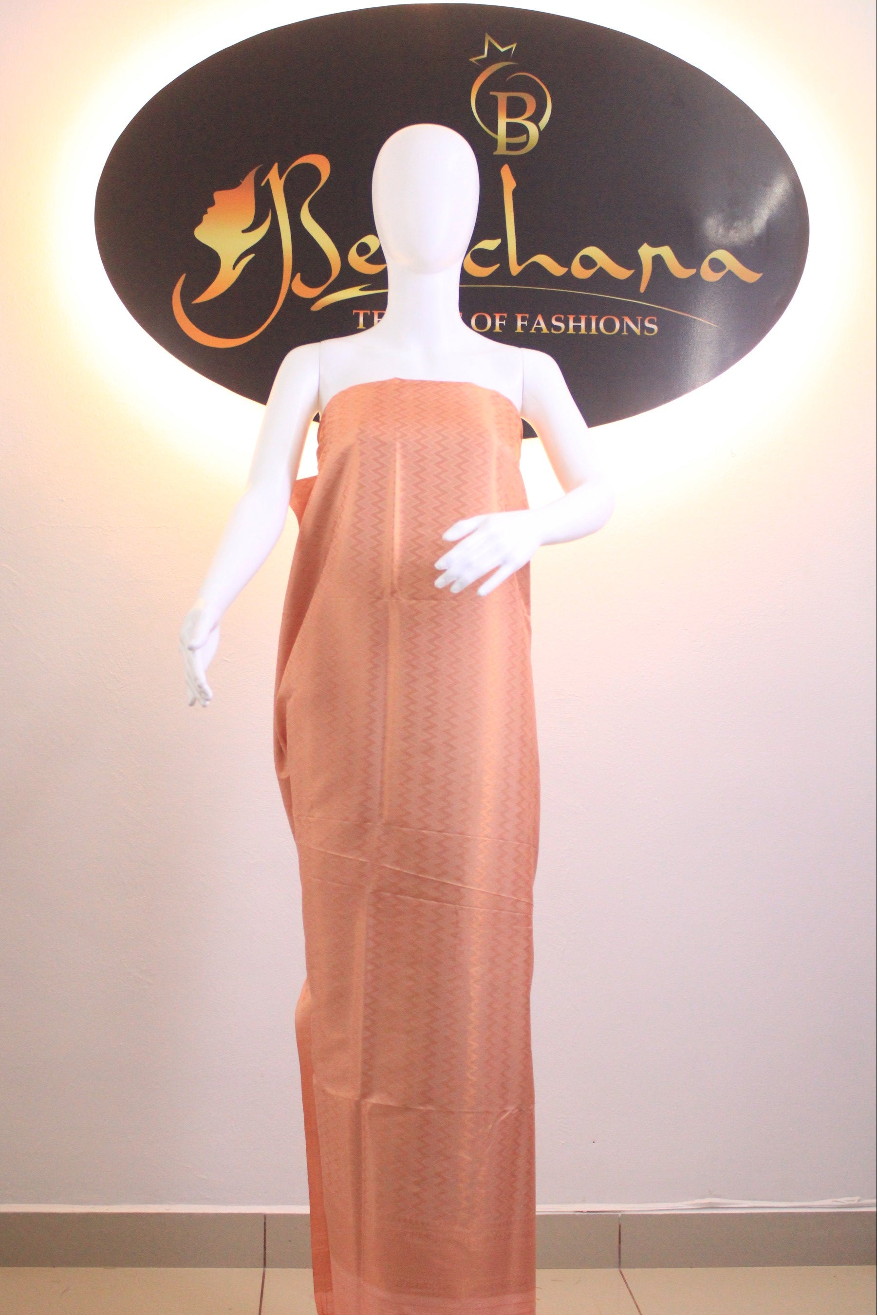 Mannequin arm with a garment in front of a branded display